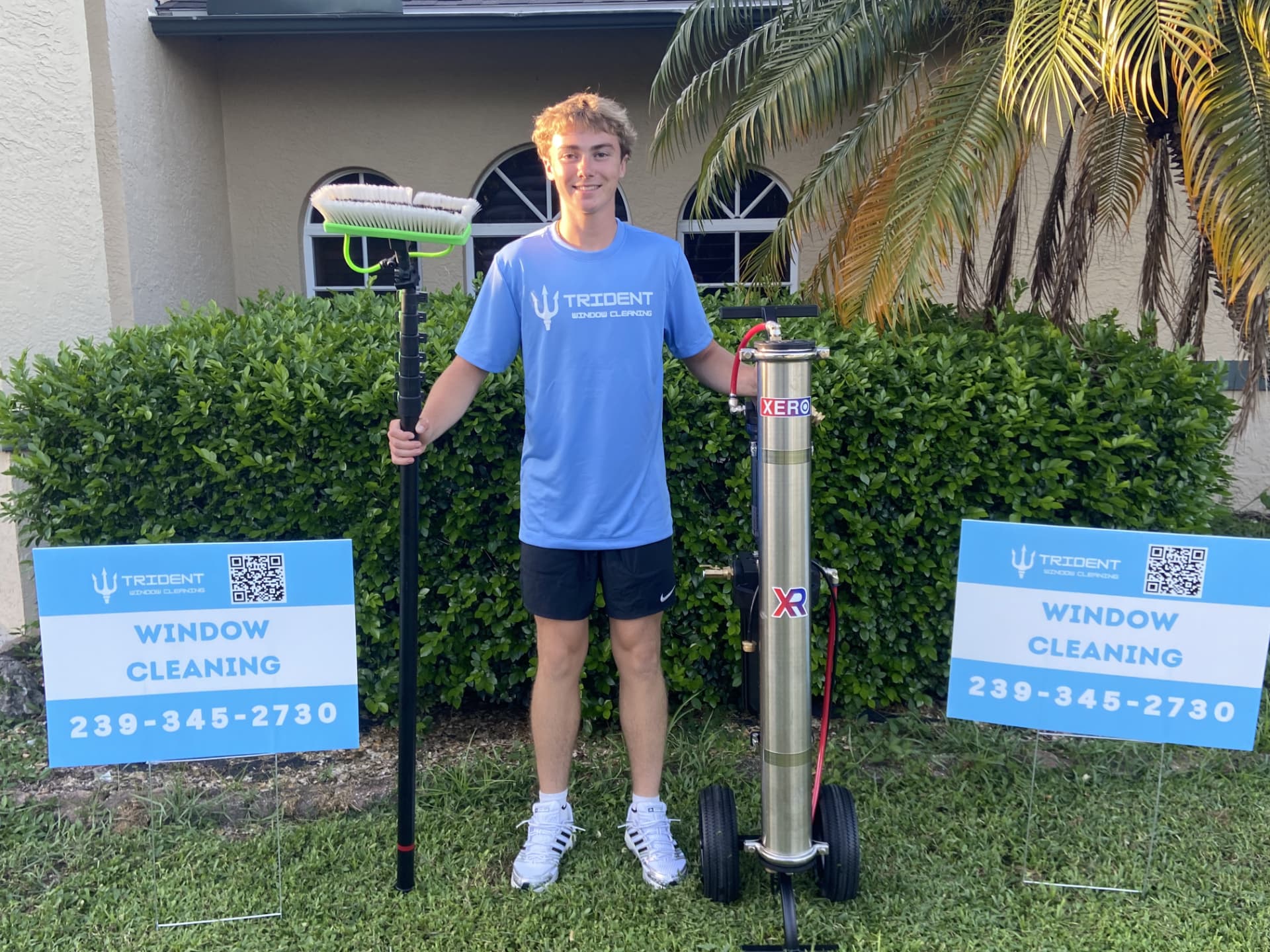 Owner of Trident Window Cleaning with water-fed pole and pure water system outside a Fort Myers home